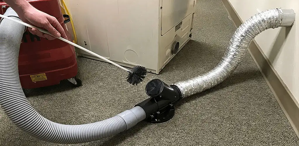 Dryer vent cleaning service removing lint from a dryer duct connection in Knoxville, TN