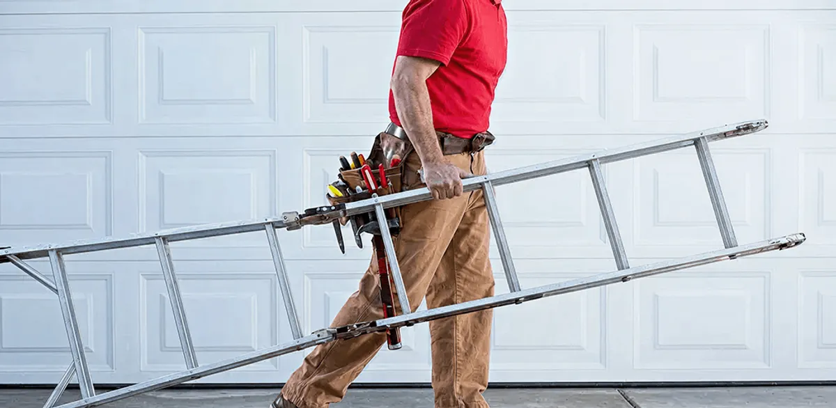 Garage door repair technician arriving with tools and ladder in Knoxville, TN