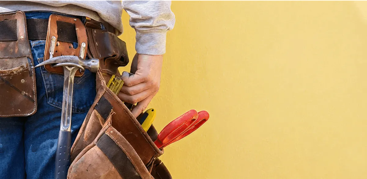 Handyman with tool belt ready for home repairs and maintenance in Knoxville, TN
