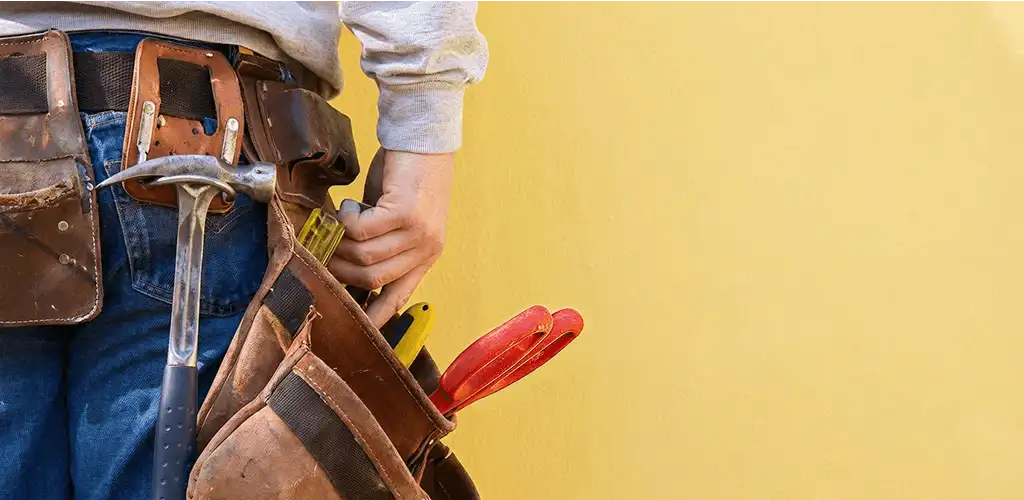 Handyman with tool belt ready for home repairs and maintenance in Knoxville, TN