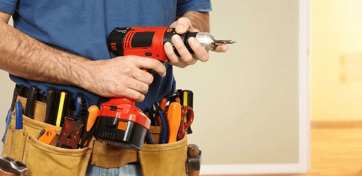 Handyman holding a power drill for home repairs and installations in Knoxville, TN