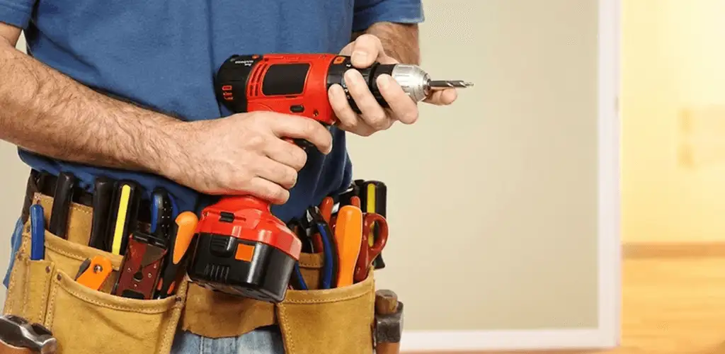 Handyman holding a power drill for home repairs and installations in Knoxville, TN