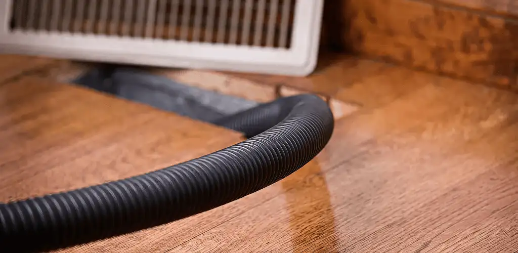 Air duct cleaning hose inserted into a floor vent for ductwork cleaning in Knoxville, TN
